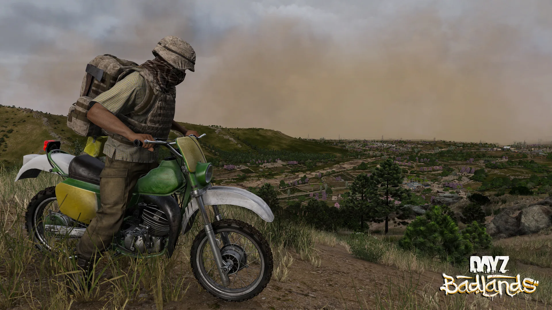 A survivor in a face wrap on a green dirt bike, with a wall of sand rolling across the hills behind him