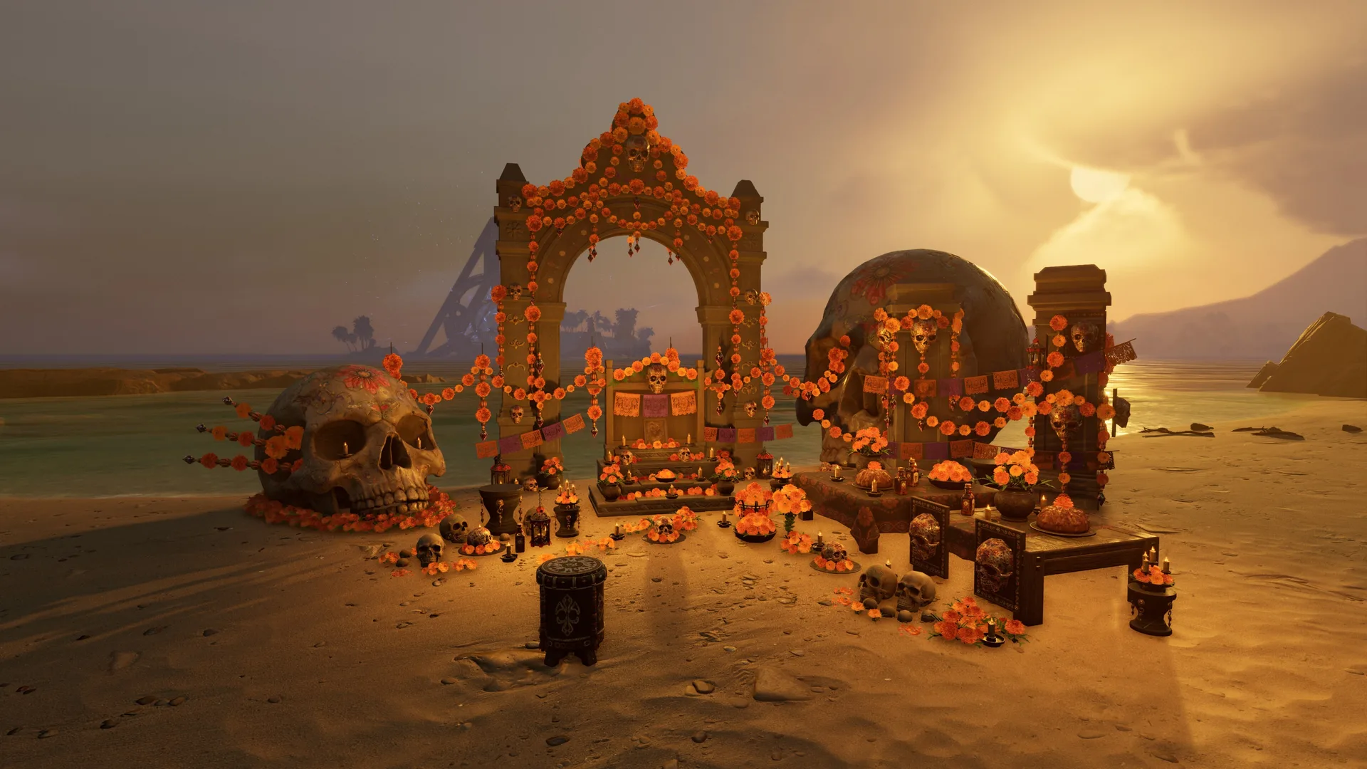 A marigold archway, giant skulls, an altar and drums arranged on a beach at sunset