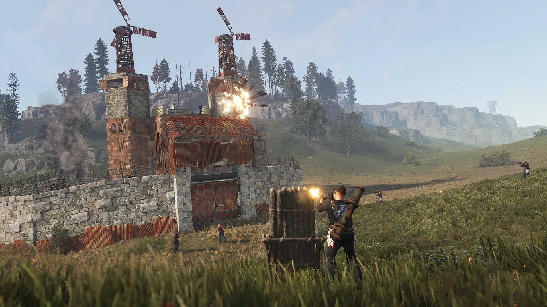 A walled Rust base with turrets on the roof, under attack in the evening
